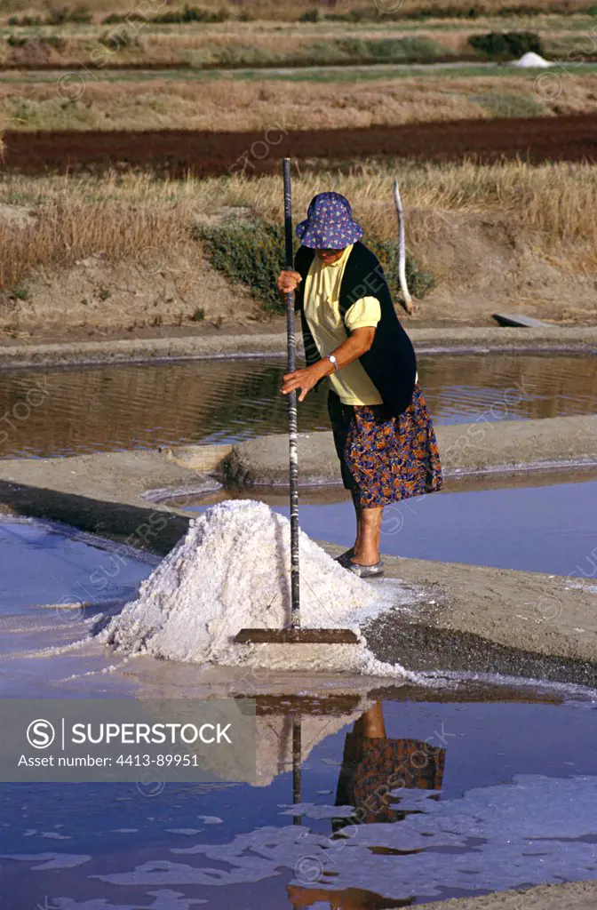 Woman harvesting the salt Noirmoutier IslandFrance