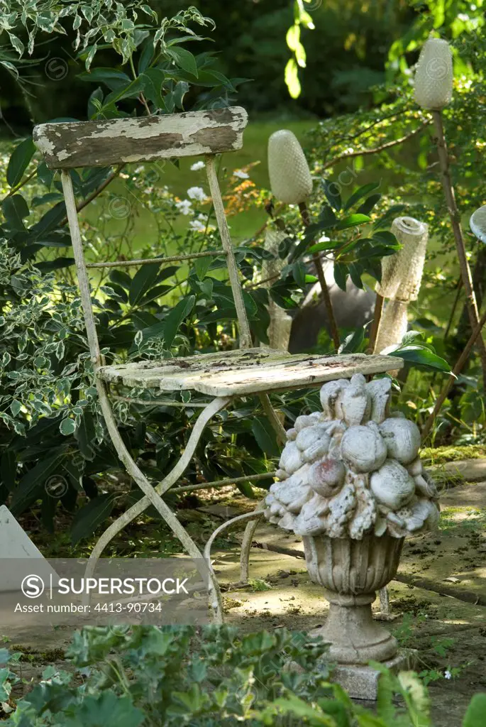 Wooden chair and garden sculpture
