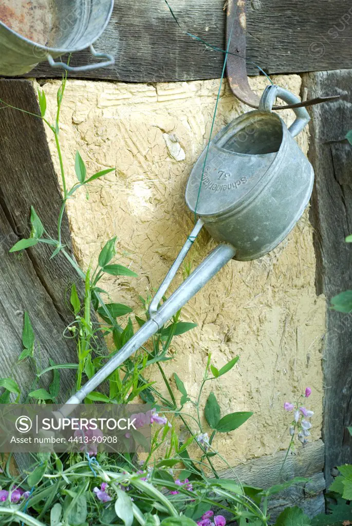 Watering can hanging on a garden