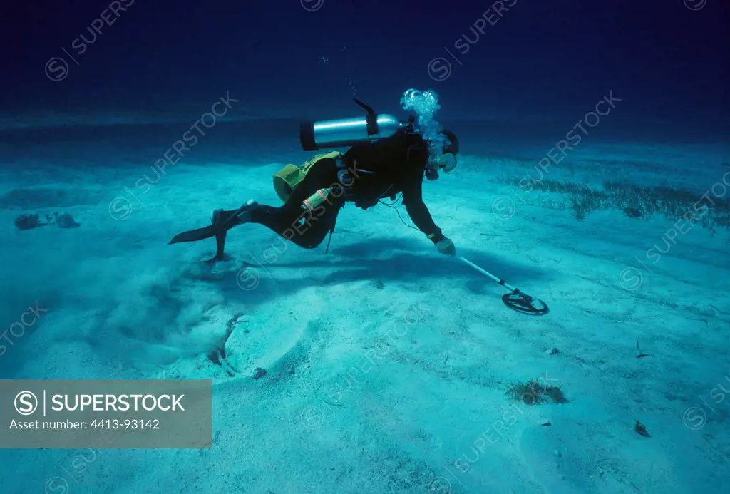 Diver searching and blowing a magnetic hit Bahamas