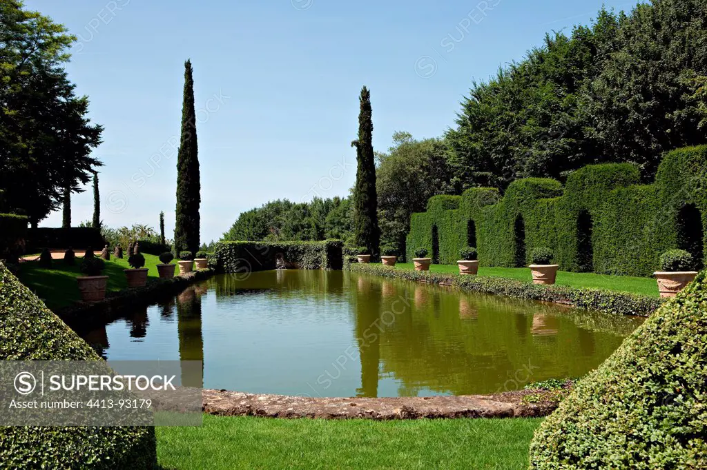 Potted boxwood and Yew trees around a reflecting pool France