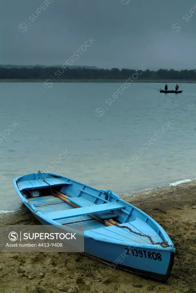 Blue boat failed on the beach of a pond France