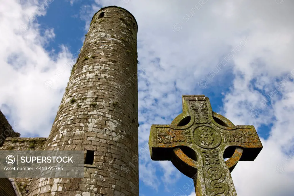 Celtic crucifix and tower in the ruins of Rock of Cashel