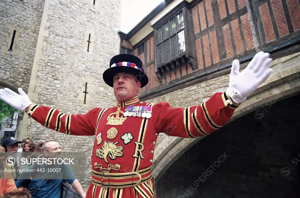 Close-up of a beefeater with his arms outstretched, Tower of London, London, England