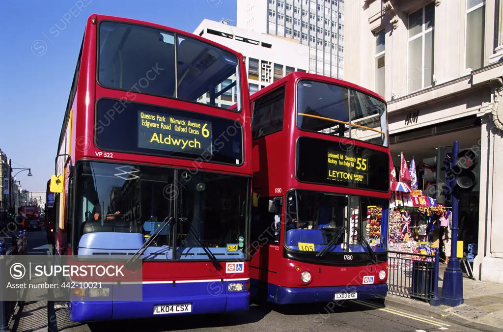Two double-decker buses on a road, London, England