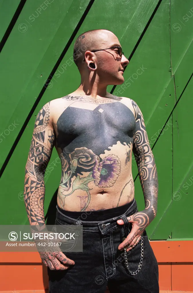Close-up of a young man with tattoos on his body