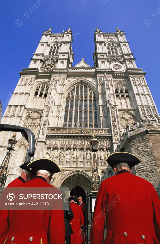Rear view of a group of people standing outside a church, Westminster Abbey, London, England