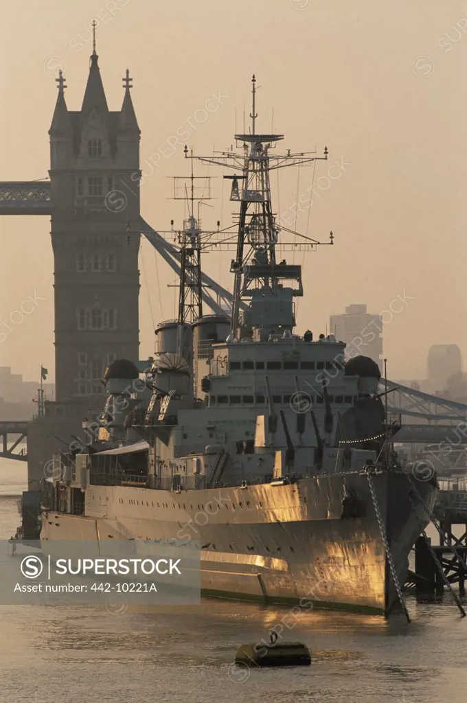 Warship anchored near a bridge, HMS Belfast, Tower Bridge, Southwark, London, England