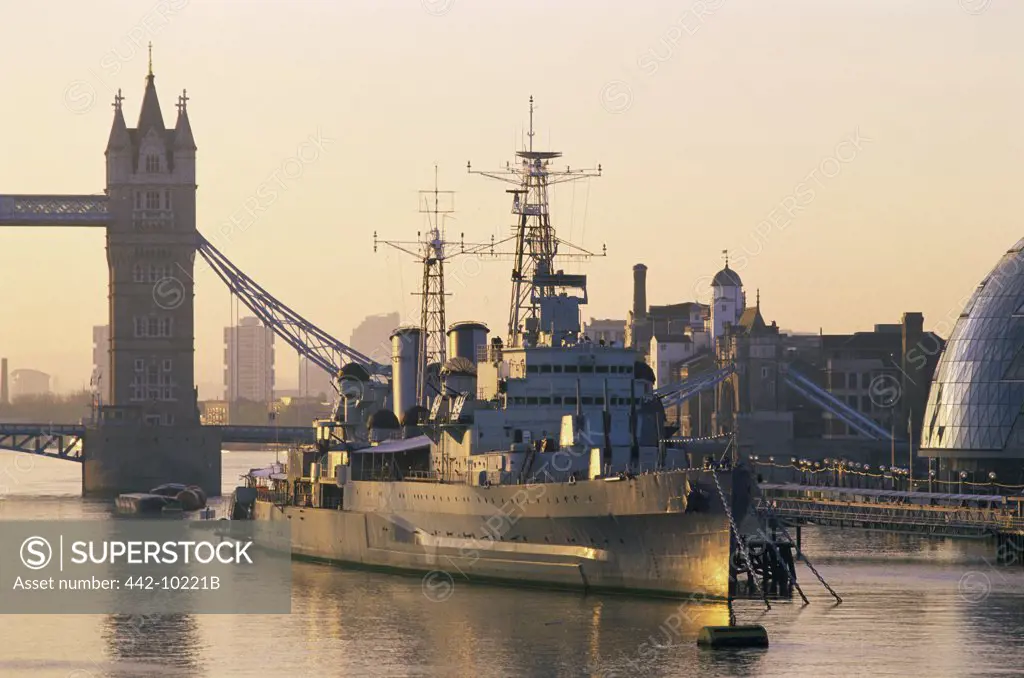 Warship anchored near a bridge, HMS Belfast, Tower Bridge, Southwark, London, England