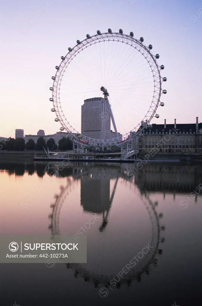 Reflection of a ferris wheel in a river, London Eye, Thames River, London, England