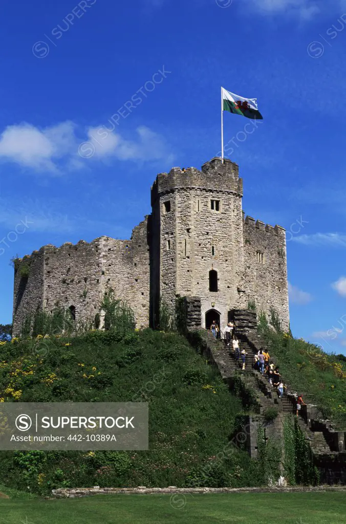 Low angle view of tourists entering into a castle, Cardiff Castle, Cardiff, Monmouthshire, Wales