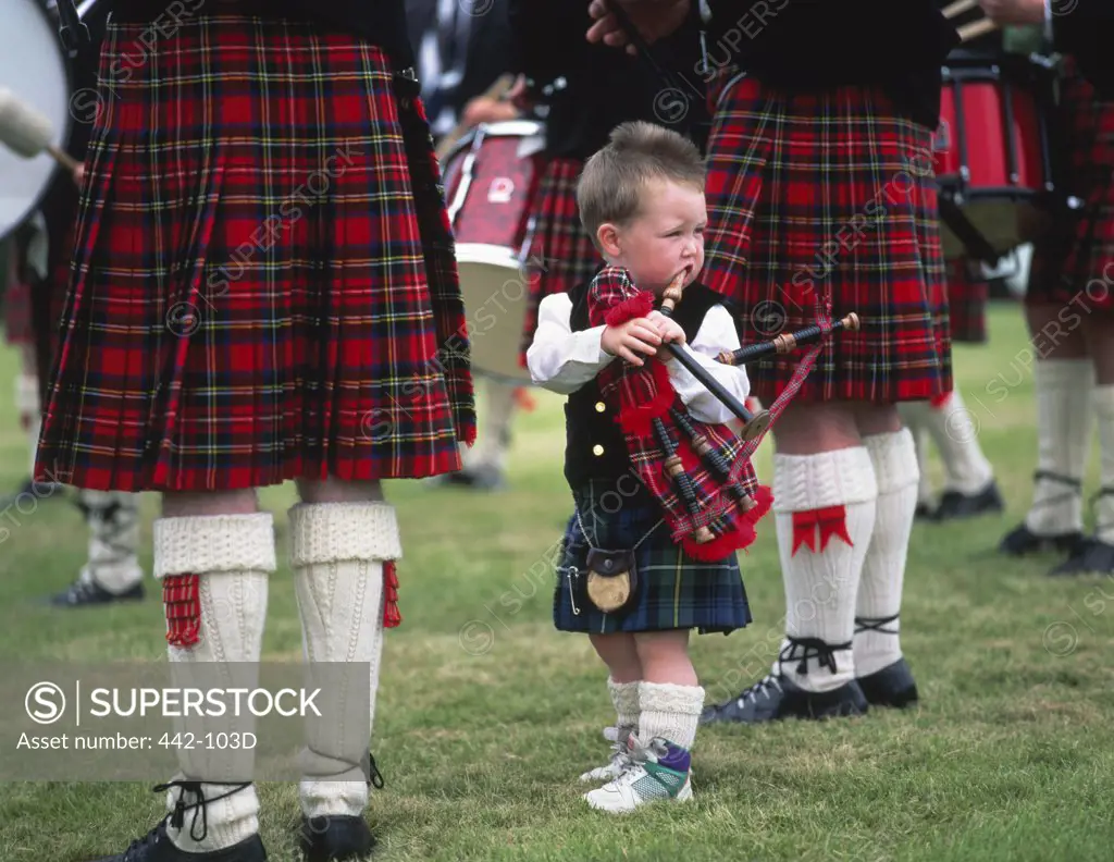 Boy standing with a bagpipe, Highland Games, Highlands, Scotland