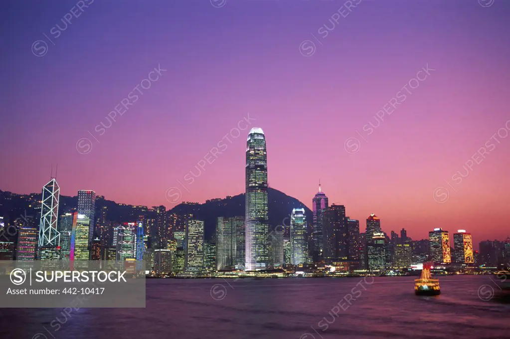 Buildings lit up at night, Victoria Harbour, Hong Kong, China