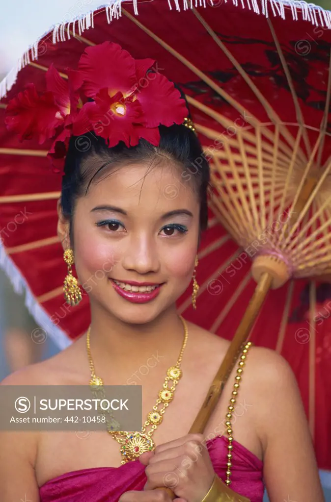 Portrait of a young woman in traditional Thai costume at a traditional festival, Chiang Mai Flower Festival, Chiang Mai, Chiang Mai Province, Thailand