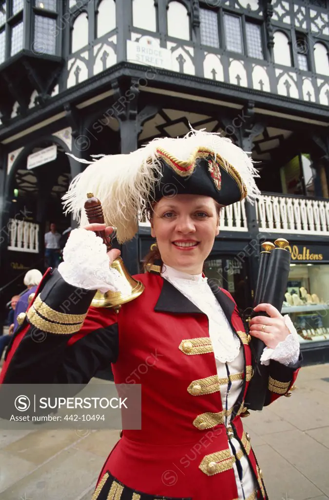 Female town crier ringing a bell, Chester, Cheshire, England