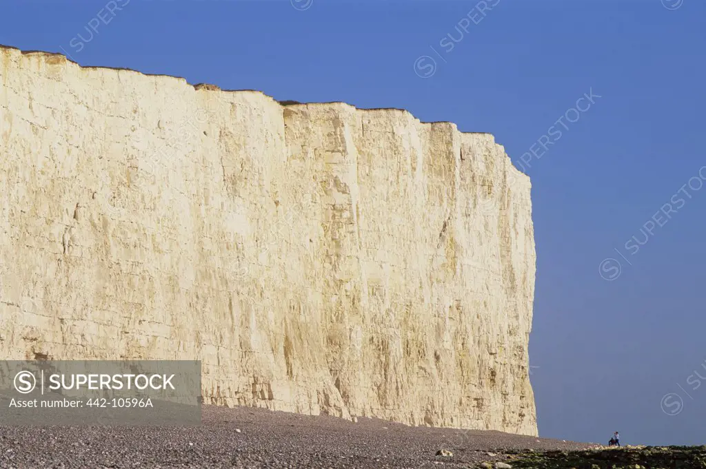 Low angle view of limestone formation on the beach, Seven Sisters, Beachy Head, Eastbourne, East Sussex, England