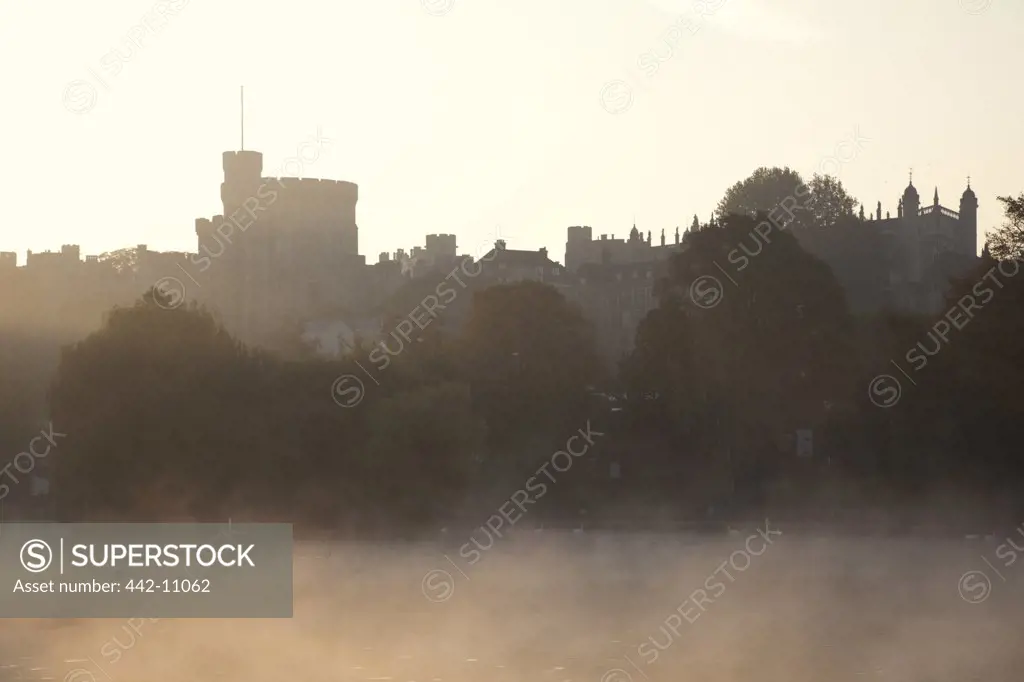 Fog over river with castle in the background, Thames River, Windsor Castle, Windsor and Eton, Berkshire, England