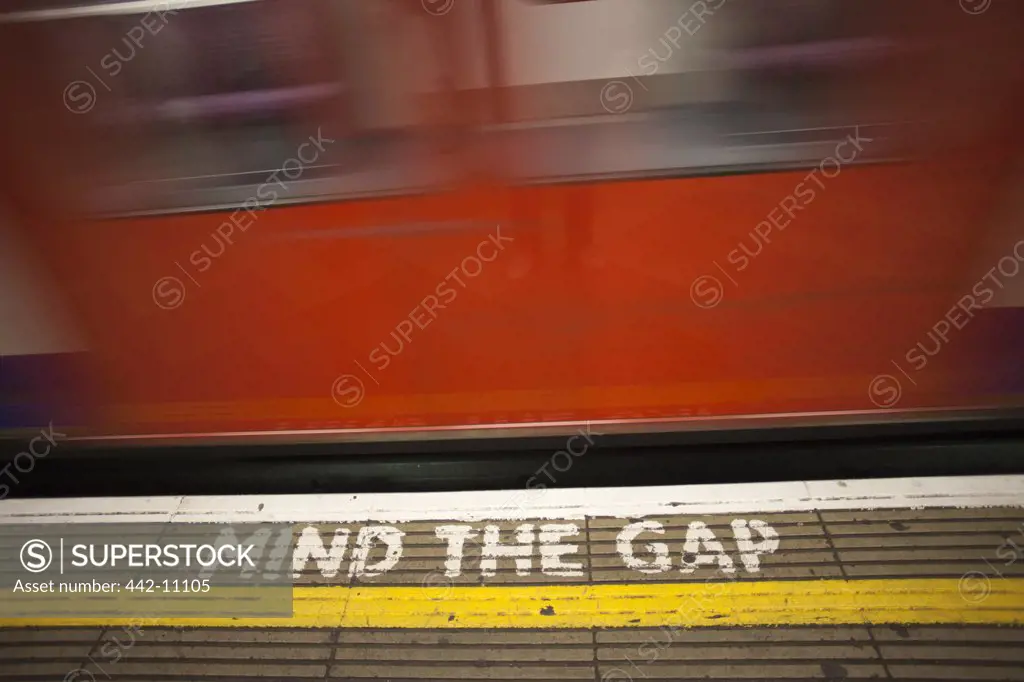 Mind The Gap warning sign on the floor of a railway platform, London Underground, London, England
