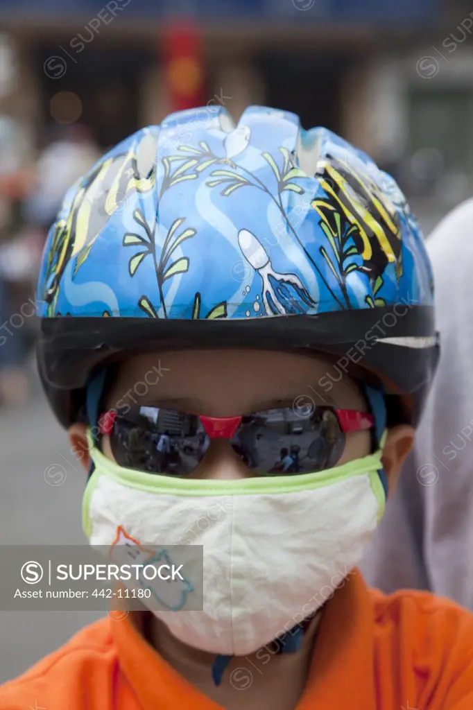 Motorcycle passenger wearing pollution mask, Ho Chi Minh City, Vietnam