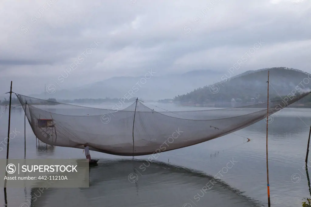 Fisherman with a commercial fishing net, Danang, Vietnam