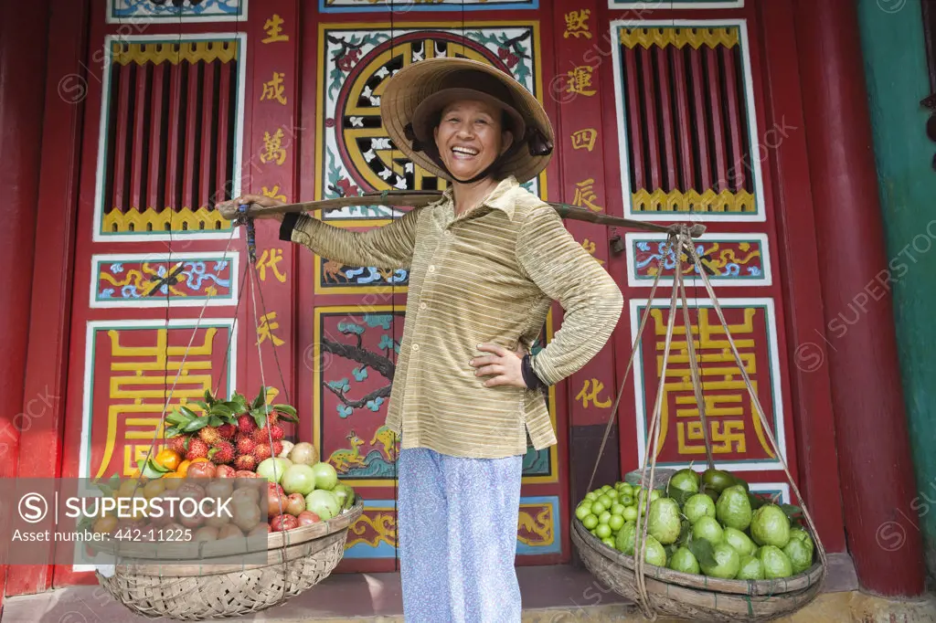 Female market vendor selling fruits, Hoi An, Vietnam
