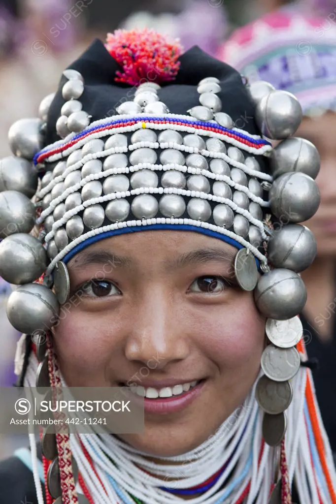 Akha teenage girl in traditional costume in a flower festival, Chiang Mai, Thailand