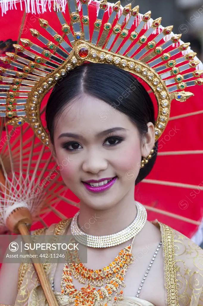 Teenage girl in traditional Thai costume in a flower festival, Chiang Mai, Thailand