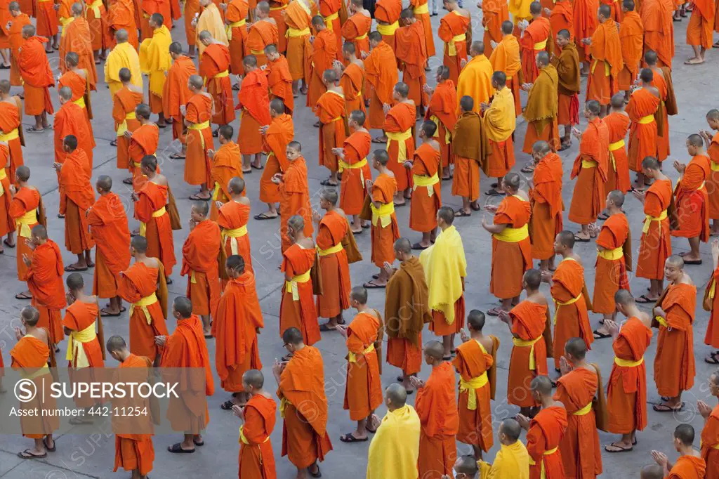 Monks praying outside a temple, Wat Phra Singh, Chiang Mai, Thailand