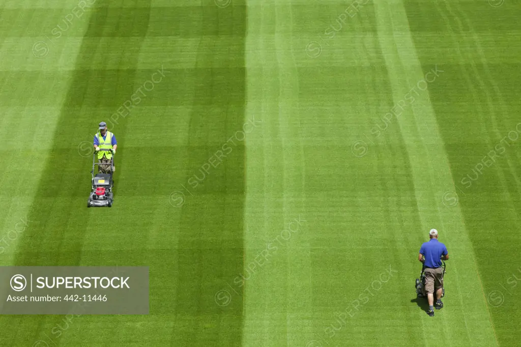 Ireland, Dublin, Greenkeepers Mowing Playing Field in The Aviva Stadium