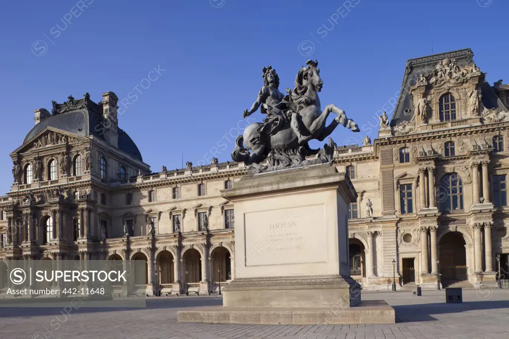 Statue Of Louis XIV in front of a building, Musee Du Louvre, Paris, Ile-de-France, France
