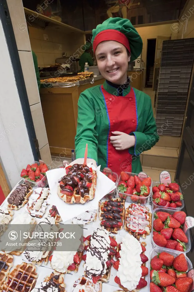 Belgium, Brussels, Girl selling waffles