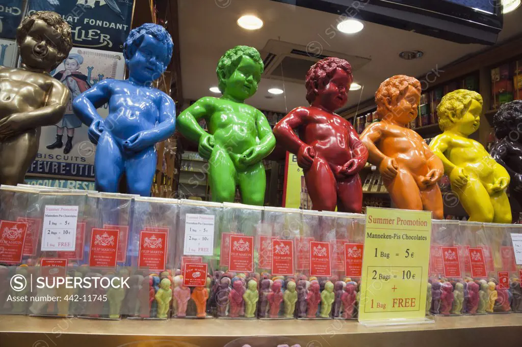 Belgium, Brussels, Chocolate shop window display of colorful Mannekin Pis Statues