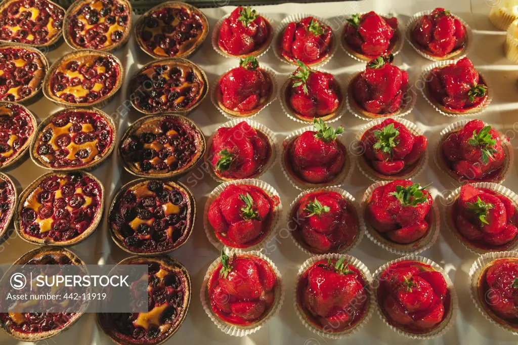 UK, England, London, Southwark, Fruit tarts on cake stall at Borough Market