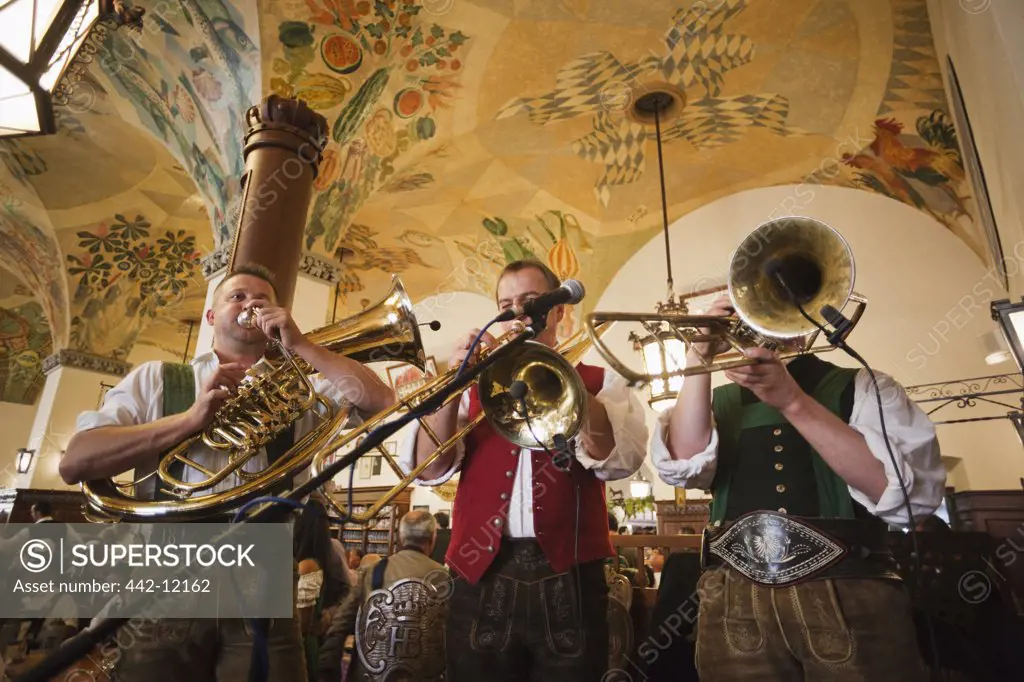 Musicians playing musical instruments in a restaurant, Hofbrauhaus, Munich, Bavaria, Germany
