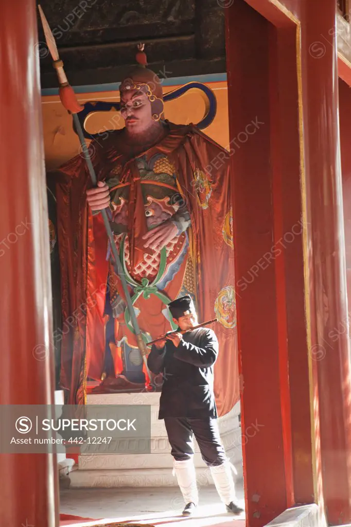 Taoist monk playing Chinese flute in a temple, Beijing Dongyue Temple, Beijing, China