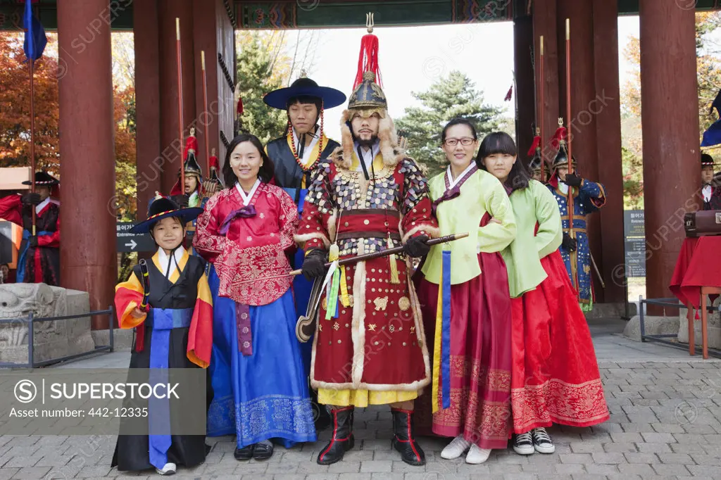 People posing with ceremonial guard in traditional uniform, Deoksugung Palace, Seoul, South Korea