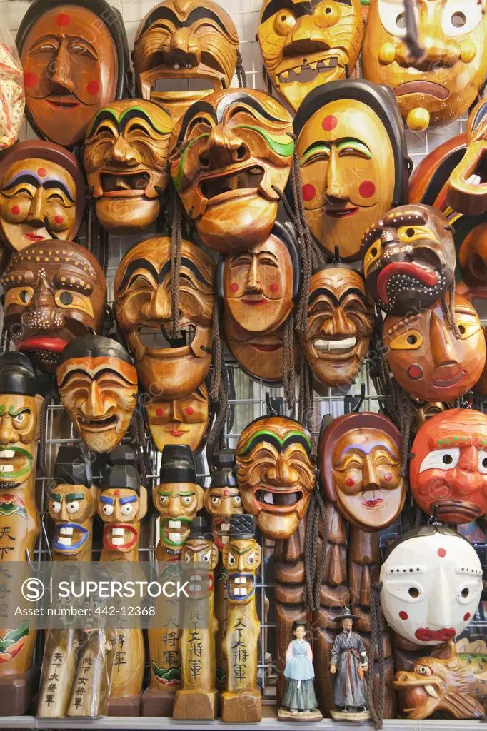 Wooden masks and statues display in a market, Namdaemun Market, Seoul, South Korea