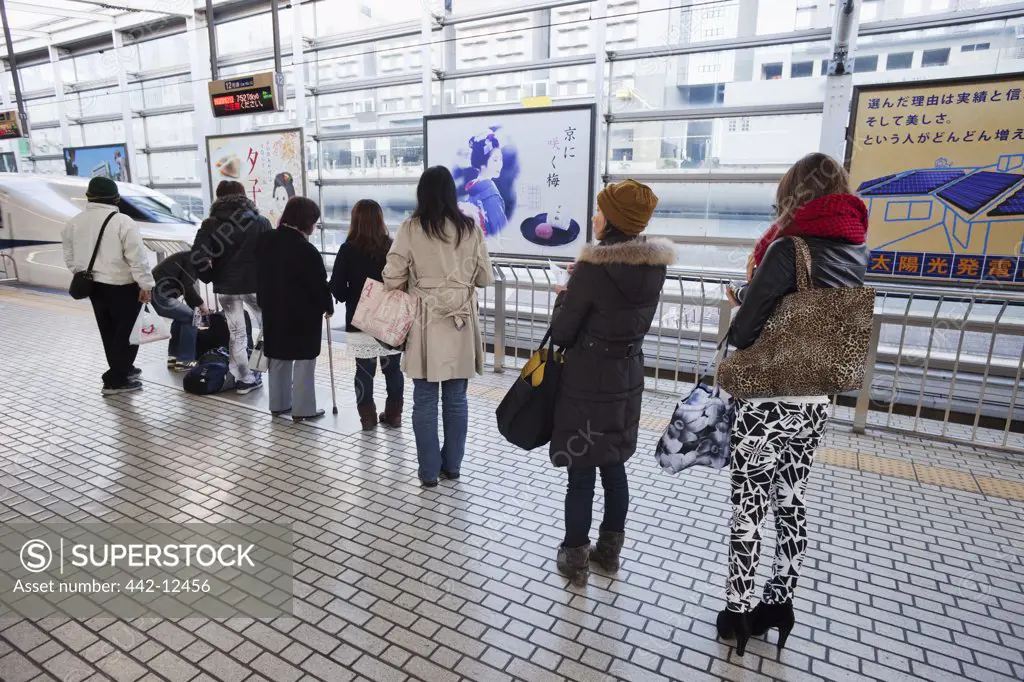 Commuters on a railway platform, Kyoto City, Kyoto Prefecture, Kinki Region, Honshu, Japan