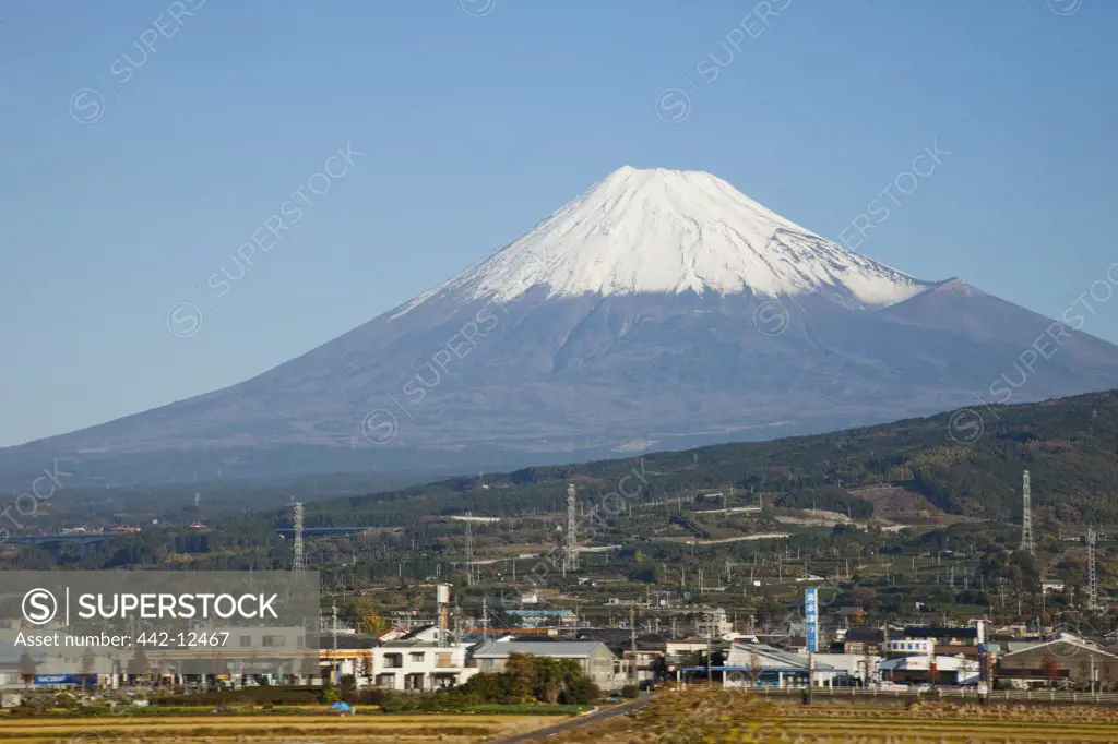 Houses in a town with a mountain in the background, Mt Fuji, Fuji, Honshu, Japan