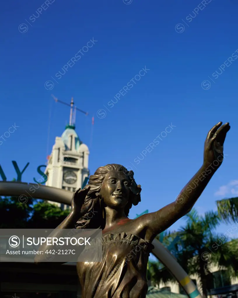 Close-up of a Hula Girl statue in front of Aloha Tower, Aloha Tower Marketplace, Honolulu, Oahu, Hawaii, USA