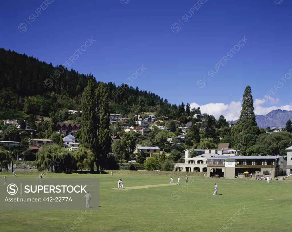 People playing cricket on a field, Queenstown, South Island, New Zealand