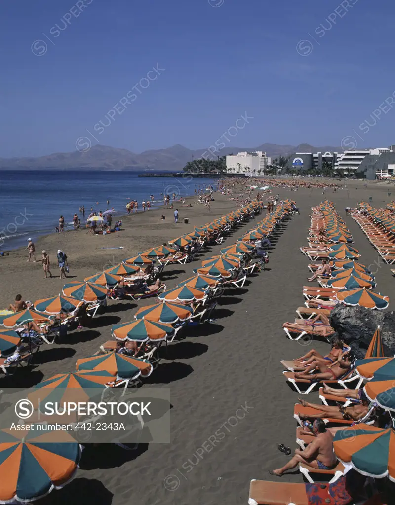 High angle view of tourists sunbathing on the beach, Puerto del Carmen, Lanzarote, Canary Islands, Spain