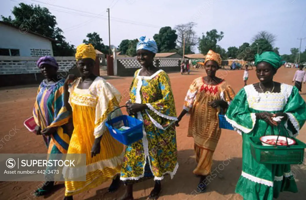 Group of mid adult women walking together on a street, Banjul, Gambia