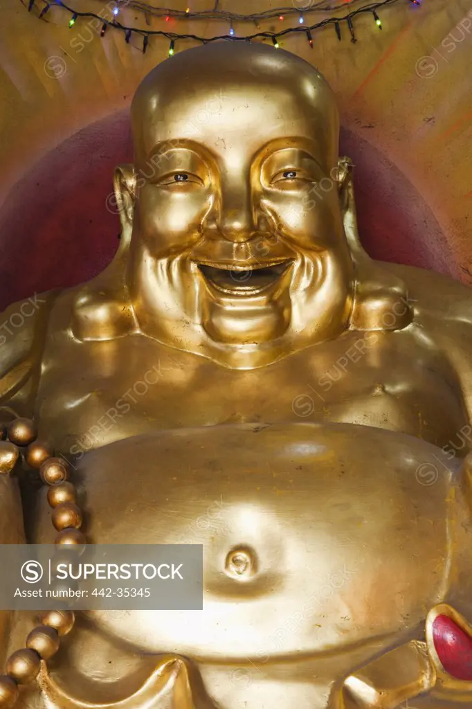 Laughing Buddha statue in a temple, Wat Traimit, Chinatown, Bangkok, Thailand