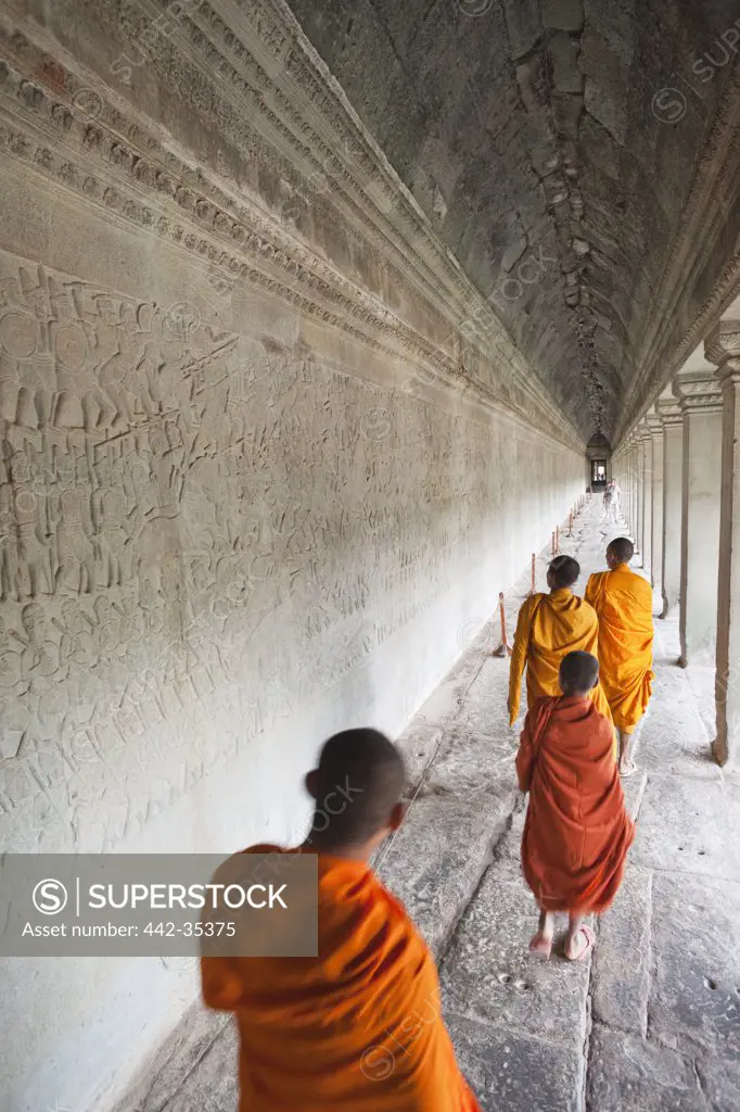 Monks walking in an alley, Angkor Wat, Siem Reap, Cambodia