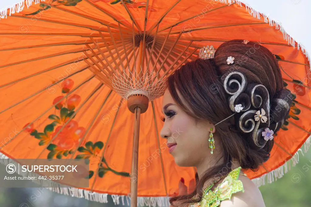 Close-up of a Cambodian bride holding an umbrella, Angkor Wat, Siem Reap, Cambodia
