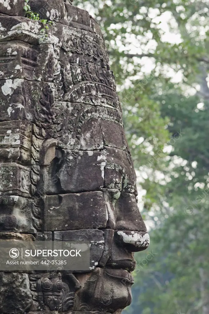 Low angle view of a statue, Bayon Temple, Angkor Thom, Angkor, Siem Reap, Cambodia