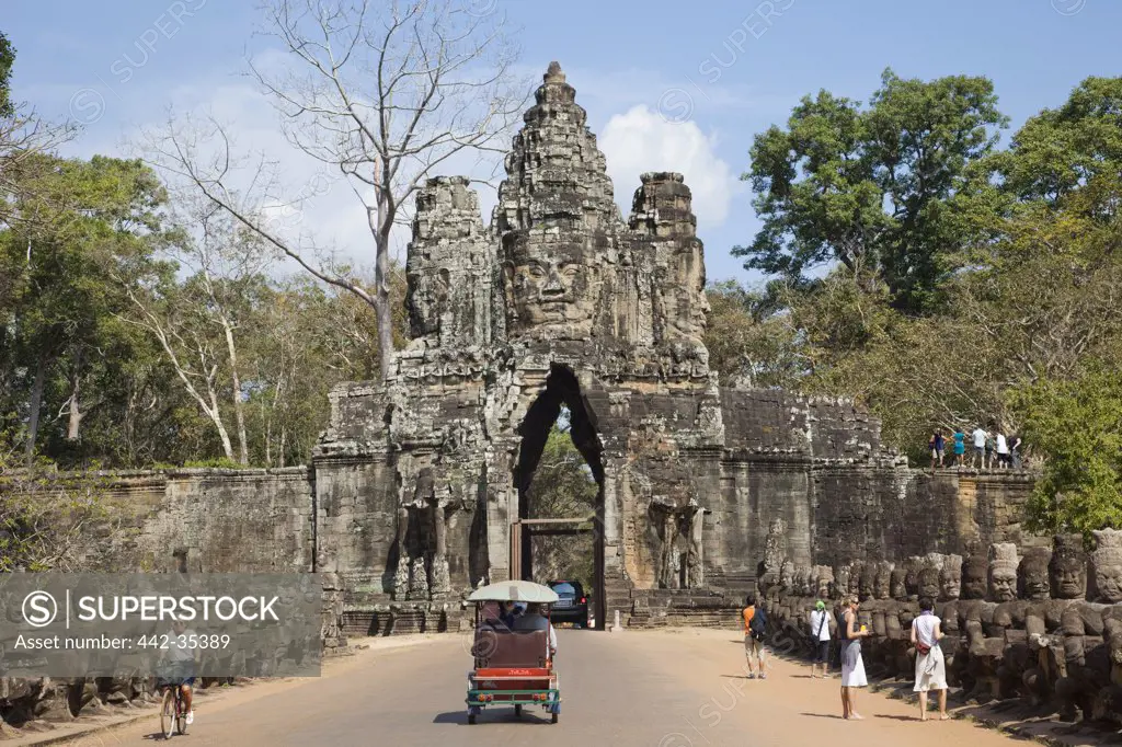 Tourists at the South gate of a temple, Angkor Thom, Angkor, Siem Reap, Cambodia