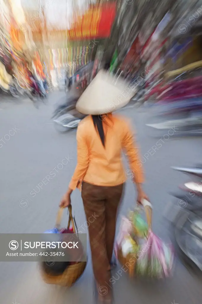Woman carrying shopping bags, Hanoi, Vietnam