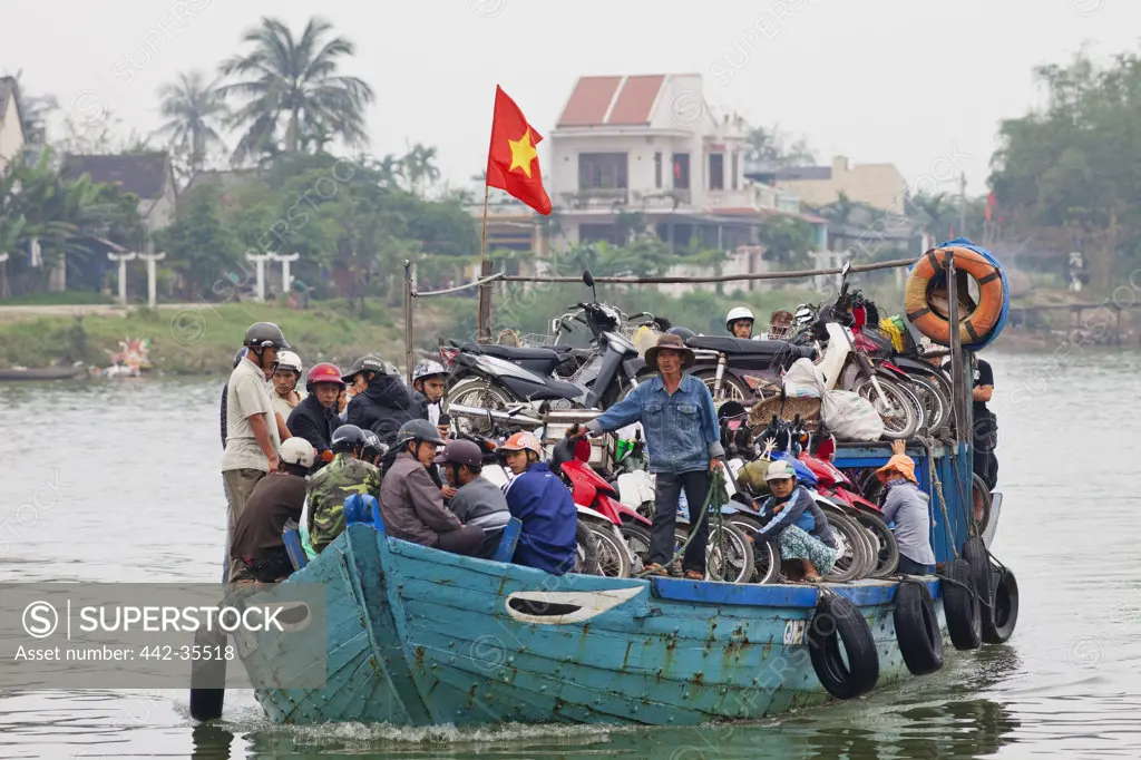 Commuters on a boat, Hoai River, Hoi An, Vietnam